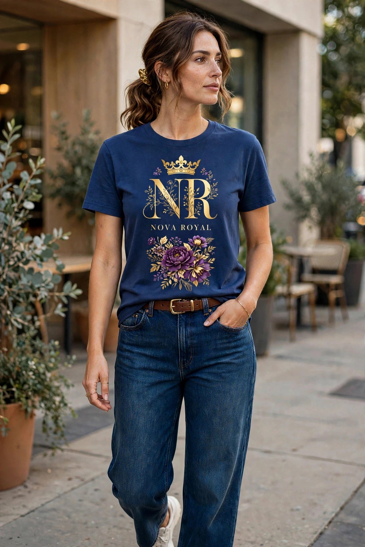 Woman wearing Blue Nova Royal Royale Floral T-Shirt with gold NR logo on top