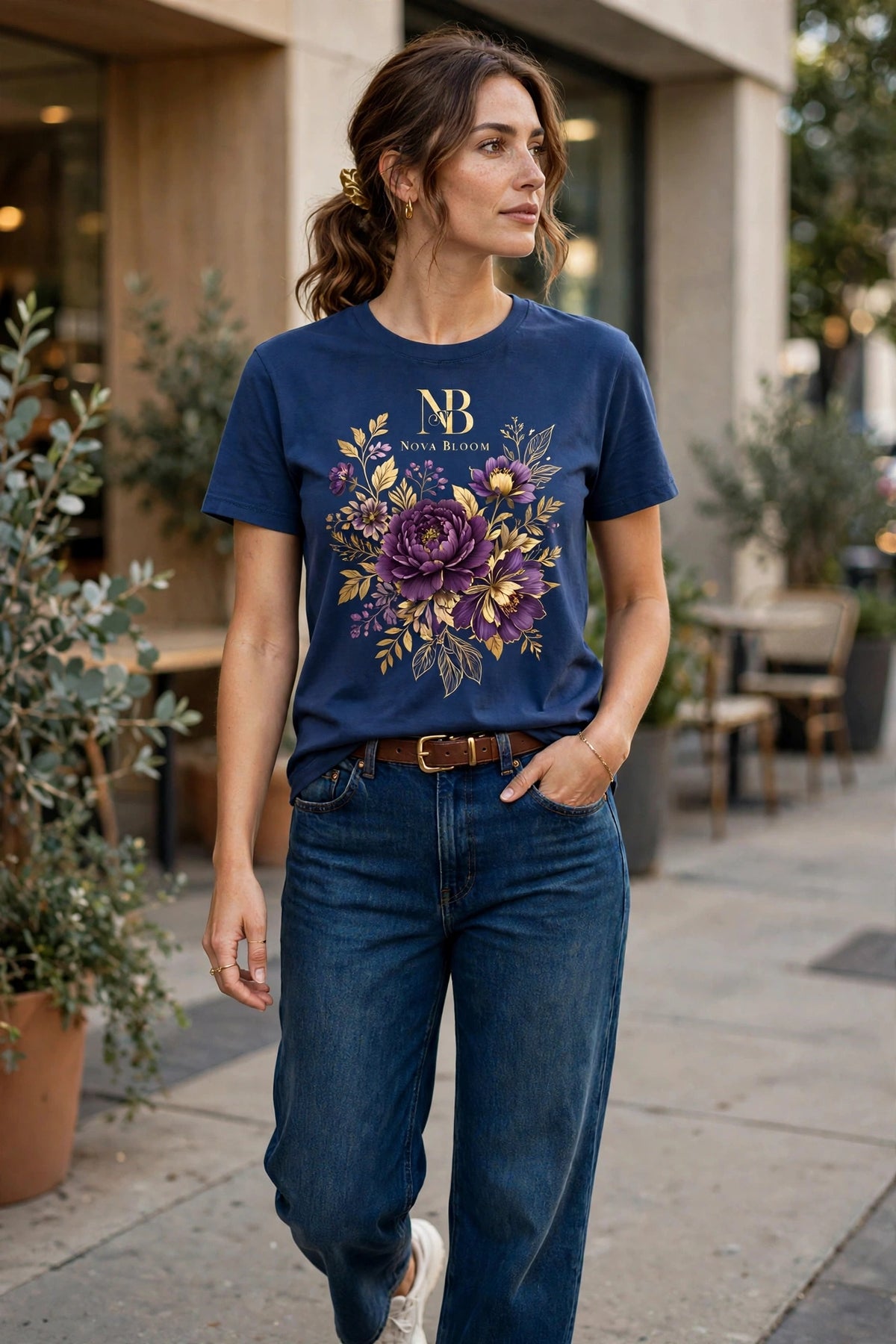Woman wearing Blue Nova Royal Royale Floral T-Shirt with gold NR logo on top